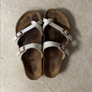 Pearl colored Birkenstock sandals with toe strap